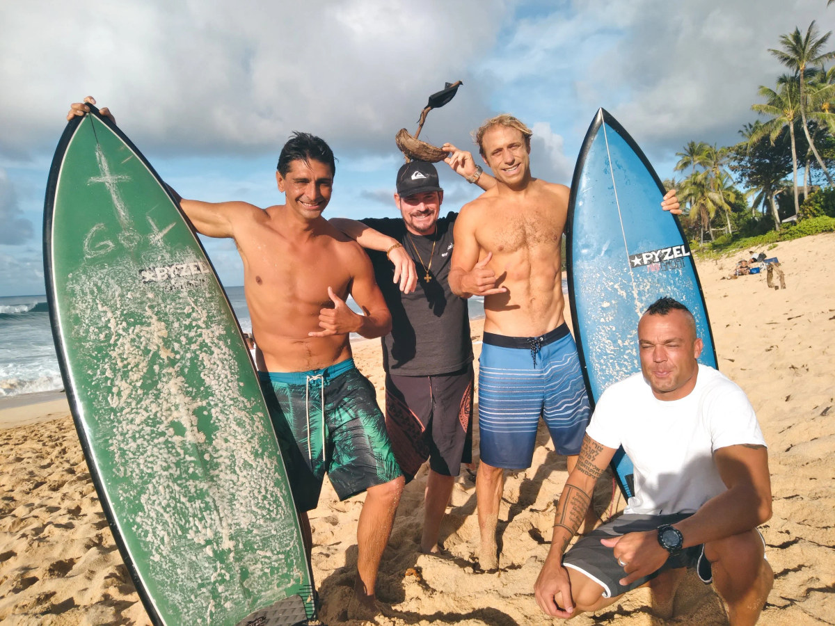 Three SFC surfers standing with their boards before a multi-day Waikīkī surf camp